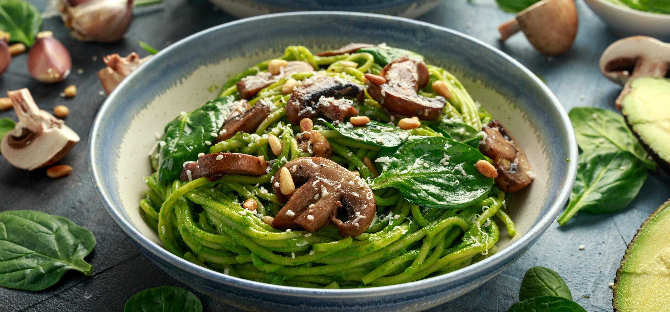 Vegan,Garlic,Mushroom,Pasta,With,Spinach,And,Avocado,Pesto,Drizzled